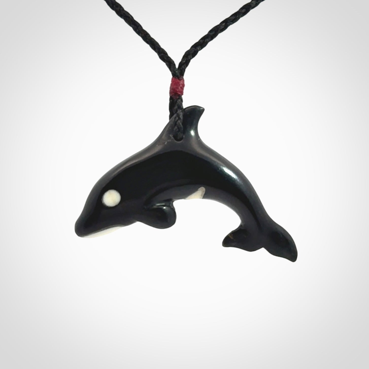 Hand carved black jade and bone Orca pendant. Ocean themed pendants hand carved from natural materials by NZ Pacific. Unique handmade jewellery.