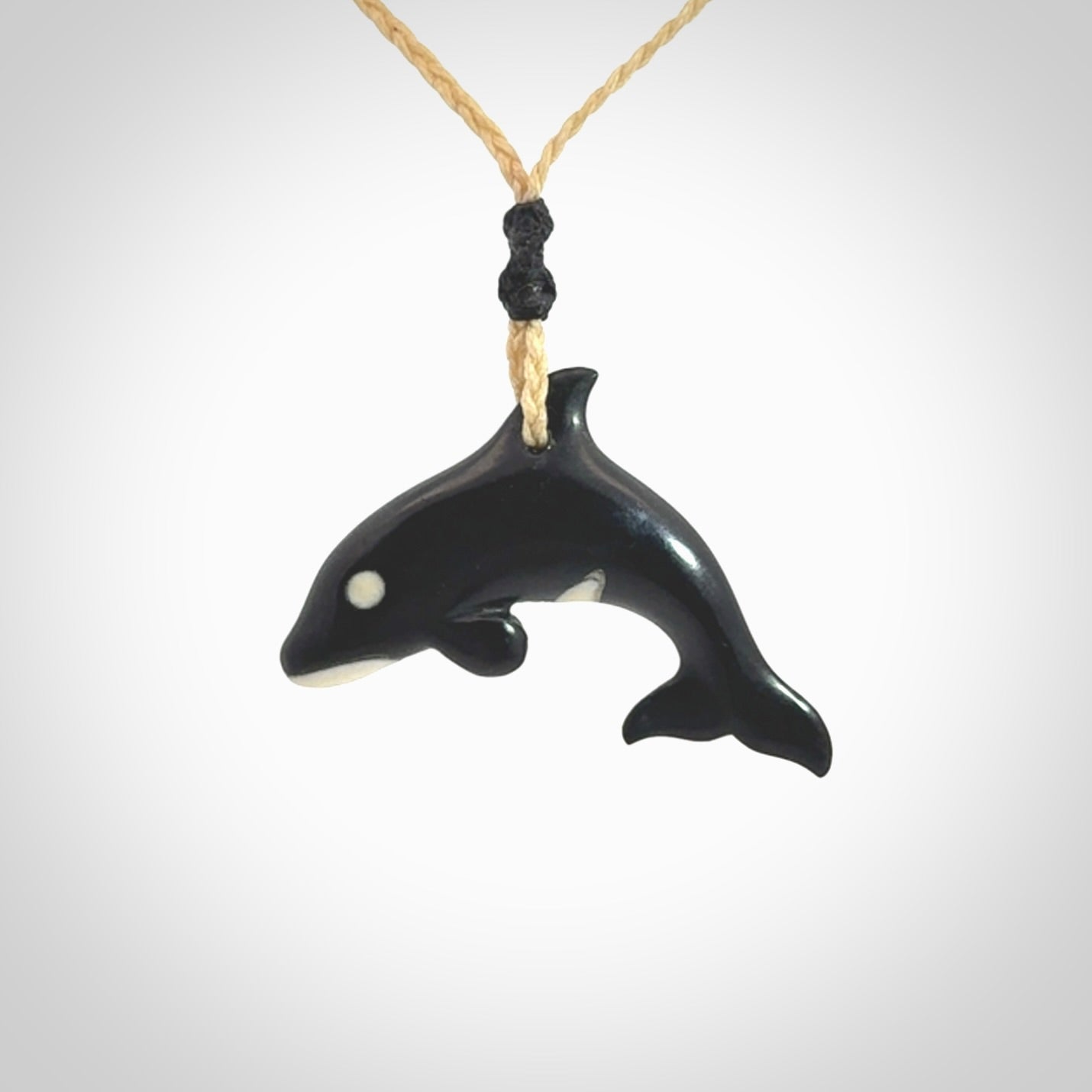 Hand carved black jade and bone Orca pendant. Ocean themed pendants hand carved from natural materials by NZ Pacific. Unique handmade jewellery.