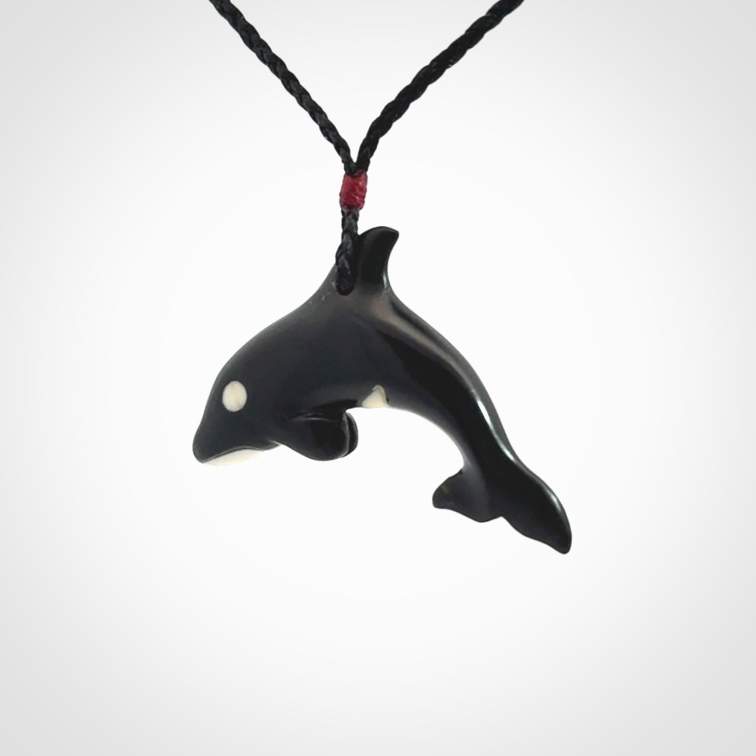 Hand carved black jade and bone Orca pendant. Ocean themed pendants hand carved from natural materials by NZ Pacific. Unique handmade jewellery.