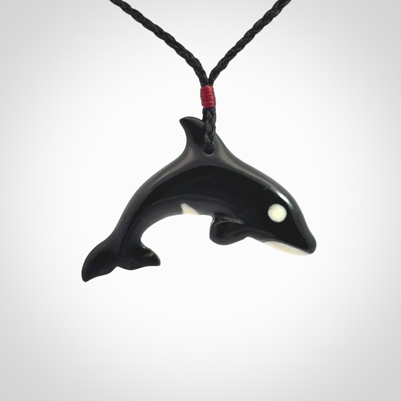 Hand carved black jade and bone Orca pendant. Ocean themed pendants hand carved from natural materials by NZ Pacific. Unique handmade jewellery.