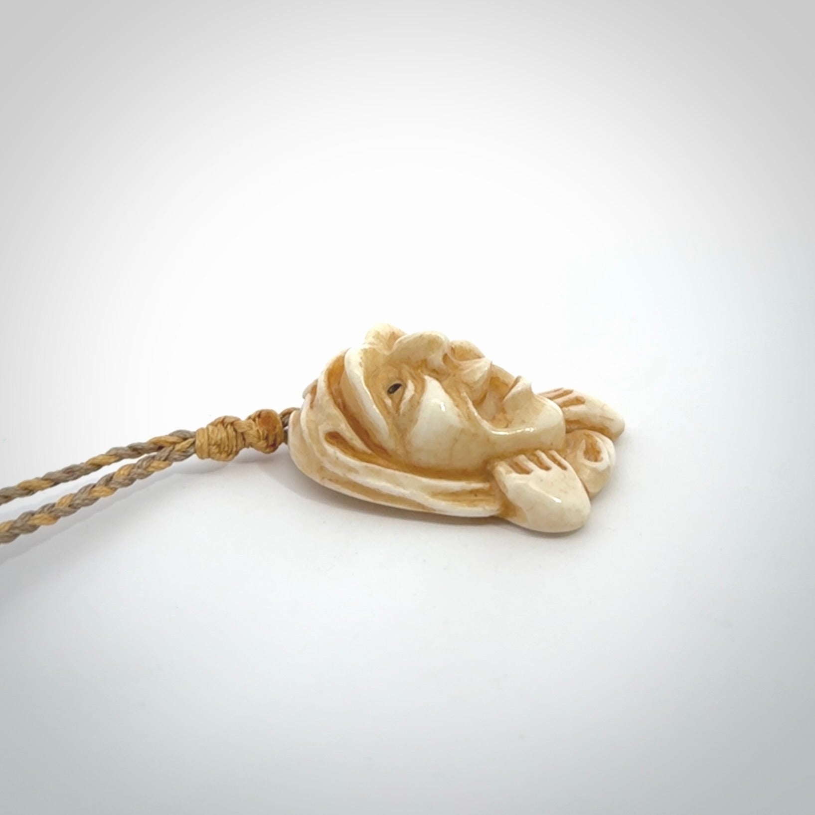 Hand carved incredible stained bone gargoyle face carving. A stunning work of art. This pendant was hand carved in bone with buffalo horn inlay for the eyes by Yuri Terenyi. A one off collectors item that has been hand crafted to be worn or displayed.
