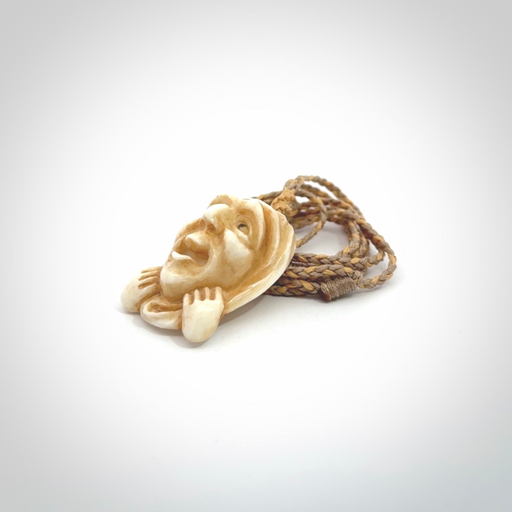 Hand carved incredible stained bone gargoyle face carving. A stunning work of art. This pendant was hand carved in bone with buffalo horn inlay for the eyes by Yuri Terenyi. A one off collectors item that has been hand crafted to be worn or displayed.