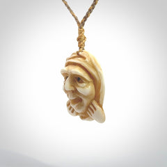 Hand carved incredible stained bone gargoyle face carving. A stunning work of art. This pendant was hand carved in bone with buffalo horn inlay for the eyes by Yuri Terenyi. A one off collectors item that has been hand crafted to be worn or displayed.