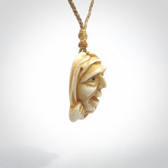 Hand carved incredible stained bone gargoyle face carving. A stunning work of art. This pendant was hand carved in bone with buffalo horn inlay for the eyes by Yuri Terenyi. A one off collectors item that has been hand crafted to be worn or displayed.