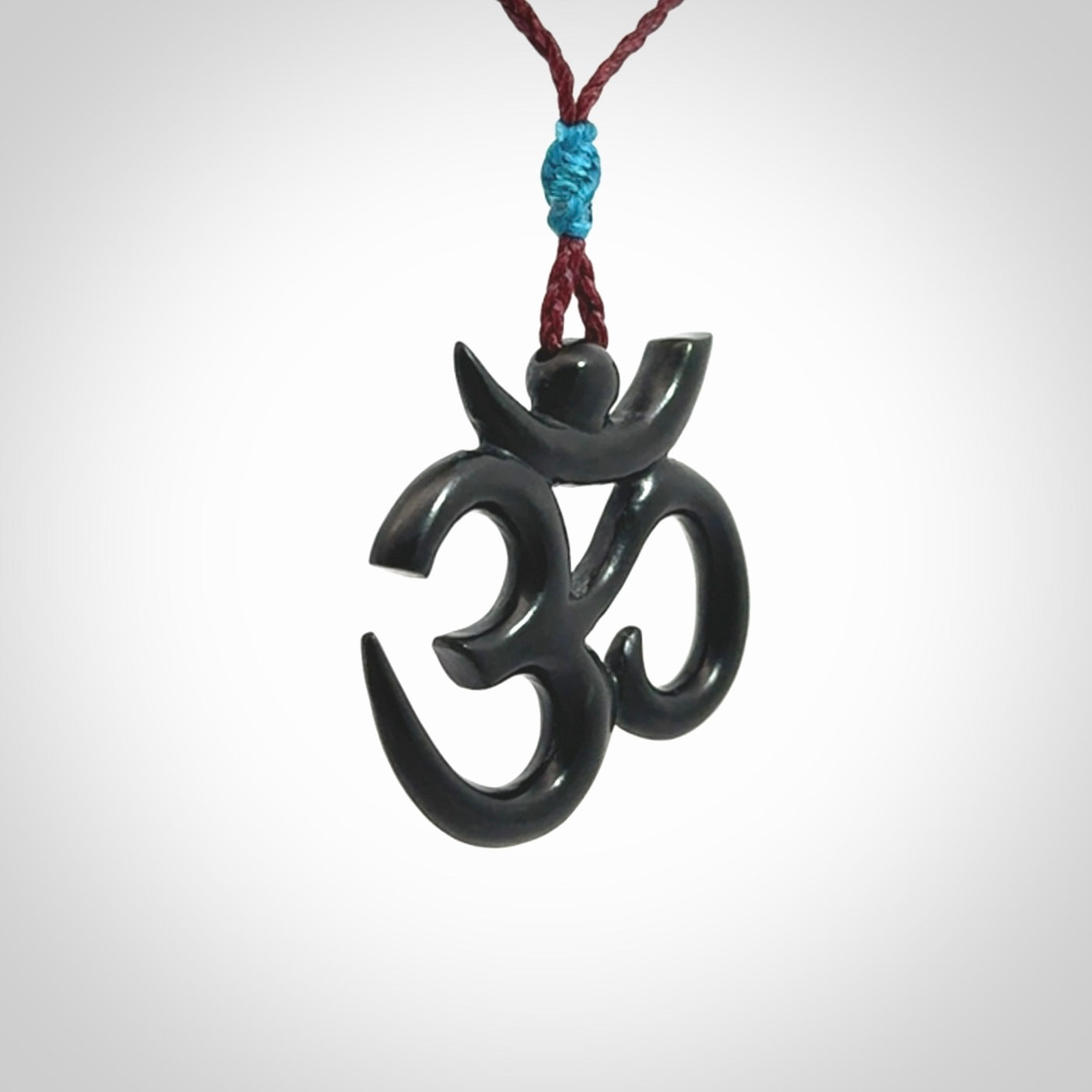 Hand carved black jade Om pendant. Carved from black jade by NZ Pacific. Unique, handmade jewellery for sale online.