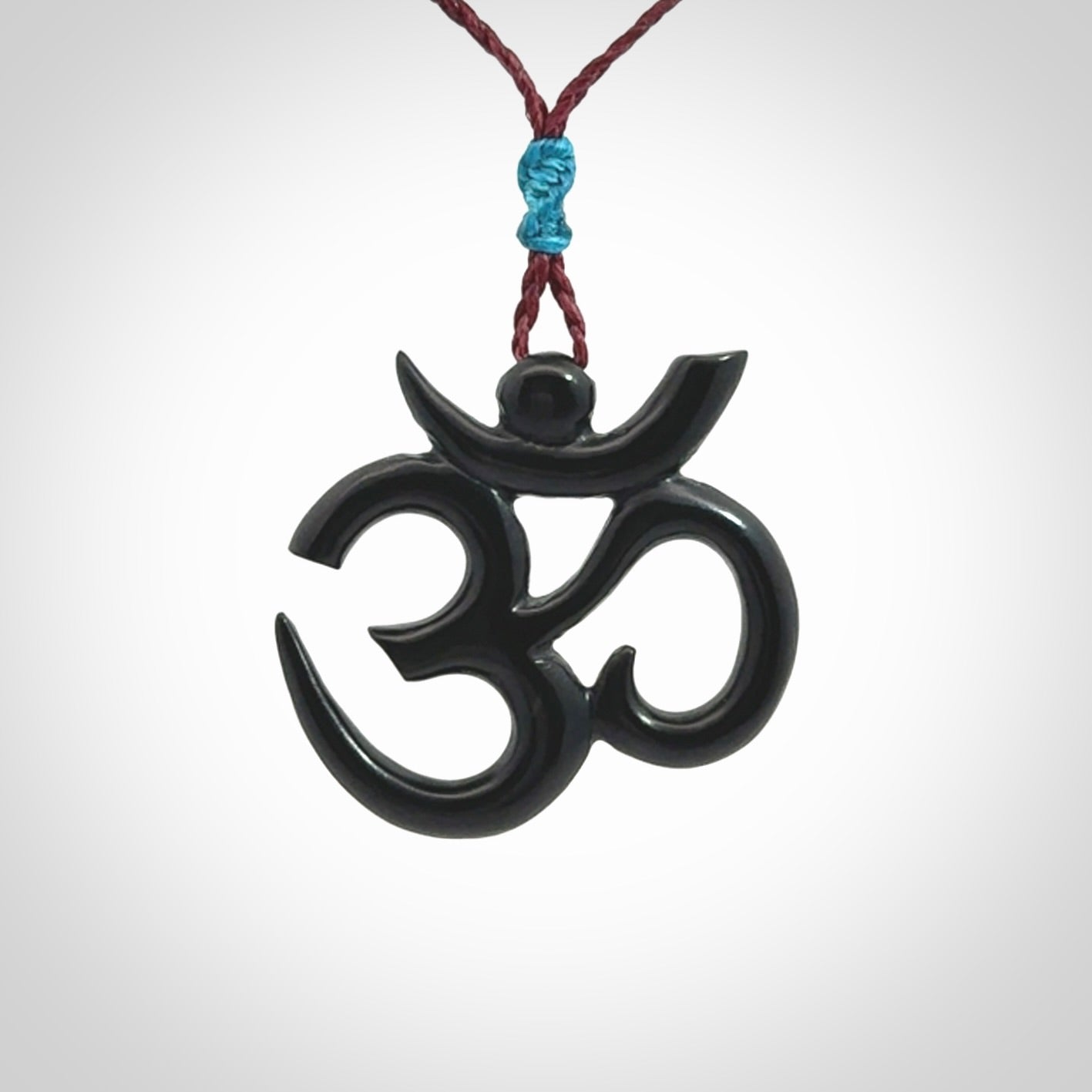 Hand carved black jade Om pendant. Carved from black jade by NZ Pacific. Unique, handmade jewellery for sale online.