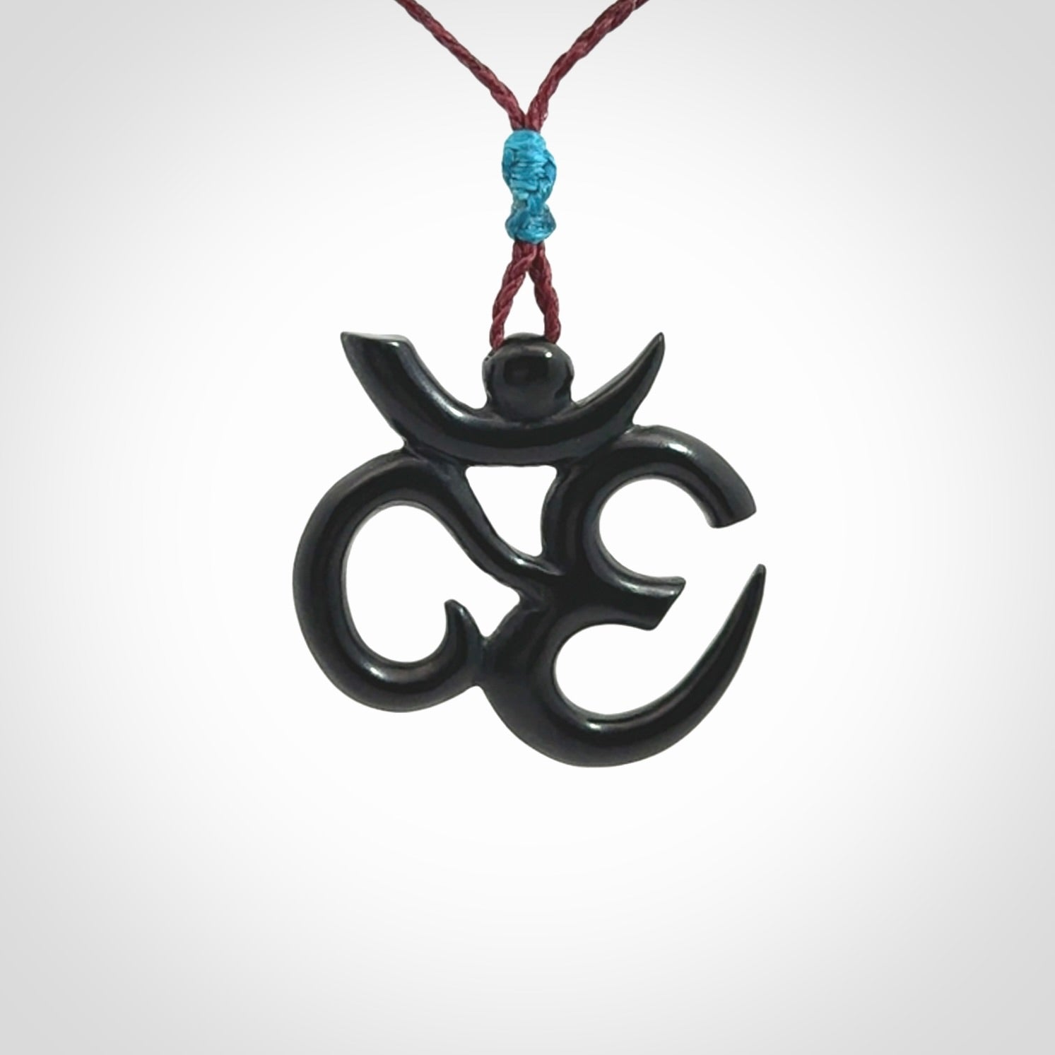 Hand carved black jade Om pendant. Carved from black jade by NZ Pacific. Unique, handmade jewellery for sale online.