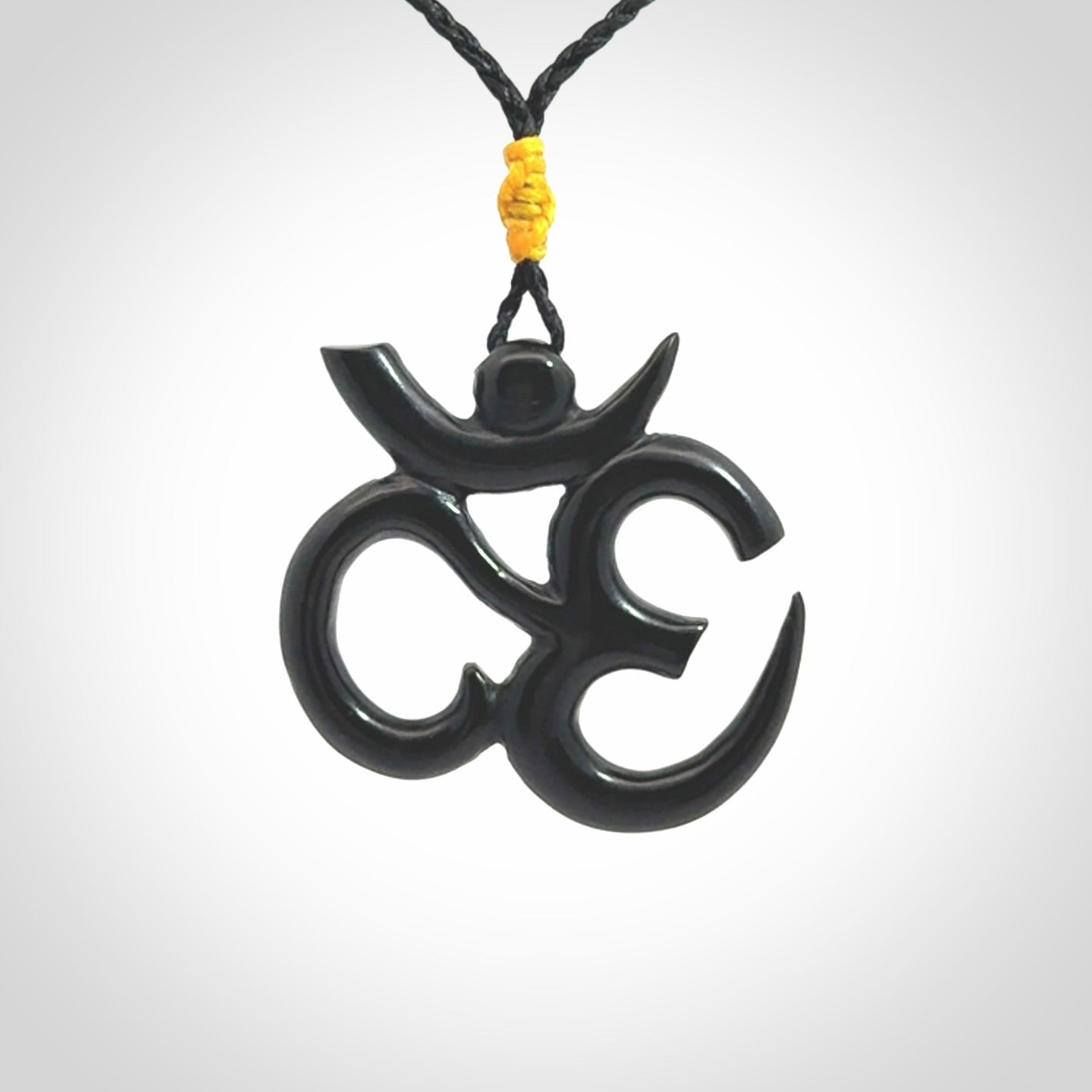 Hand carved black jade Om pendant. Carved from black jade by NZ Pacific. Unique, handmade jewellery for sale online.