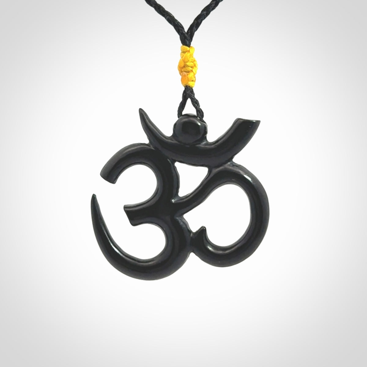 Hand carved black jade Om pendant. Carved from black jade by NZ Pacific. Unique, handmade jewellery for sale online.