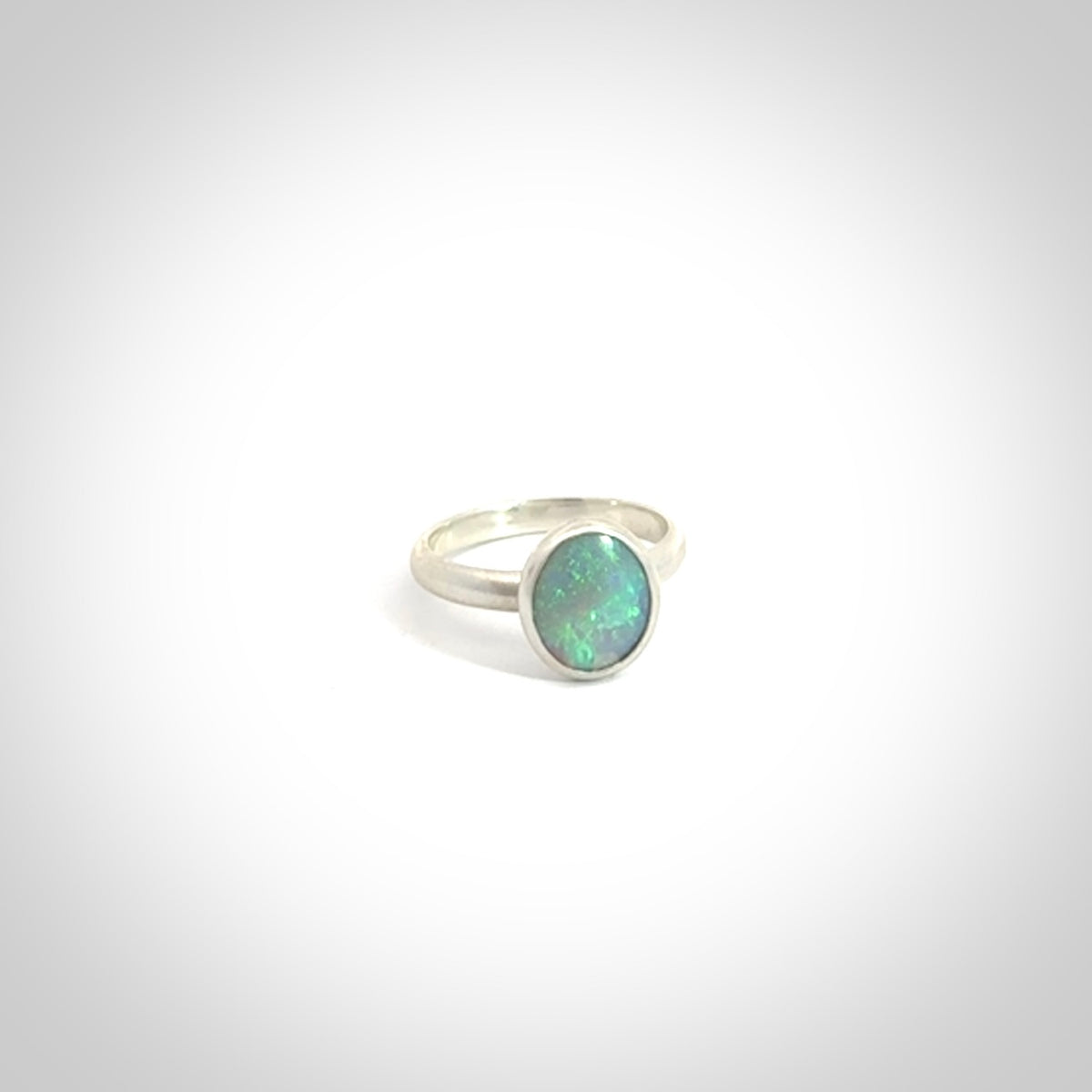 This is a handcrafted real opal ring with sterling silver. The colours are a gorgeous turquoise blue. This is a solid little work of art. We ship this worldwide for free and are happy to answer any questions that you may have about these or other products on our website.