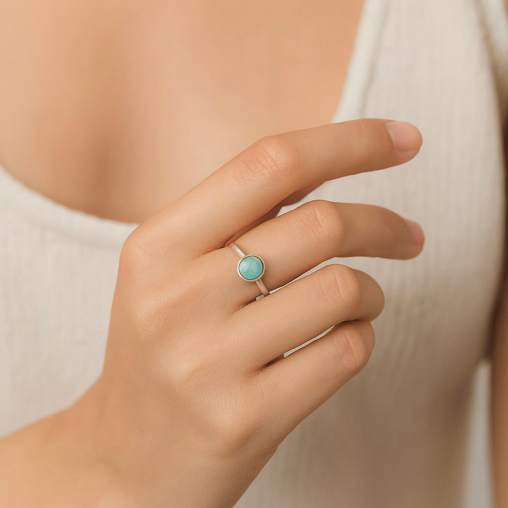 This photo shows an opal ring being worn