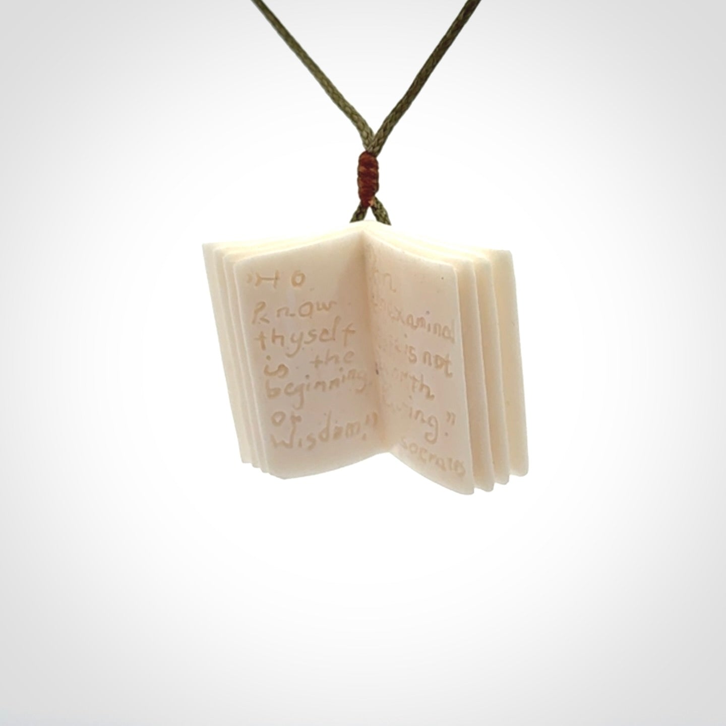 Hand carved open book pendant, hand made in bone.