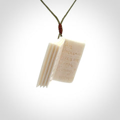 Hand carved open book pendant, hand made in bone.