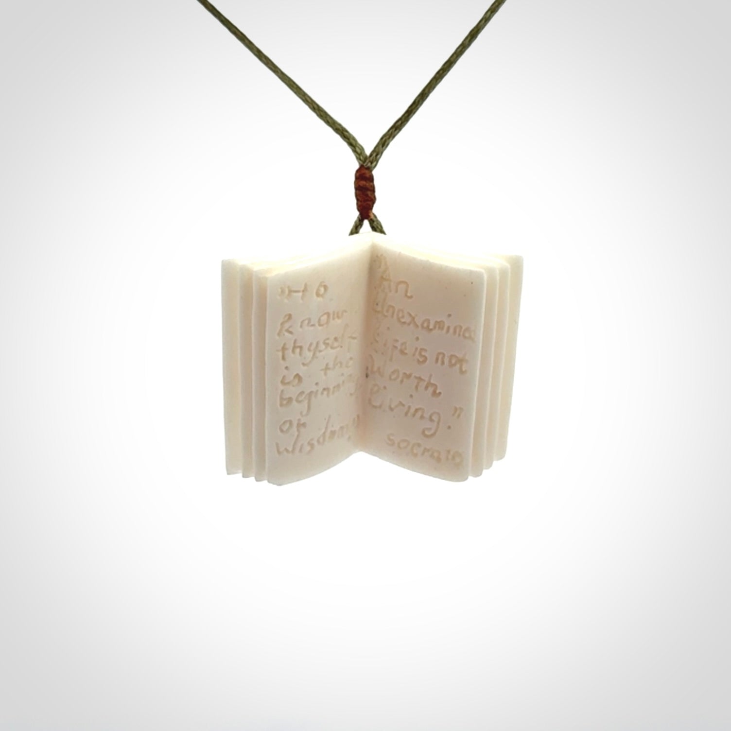 Hand carved open book pendant, hand made in bone.