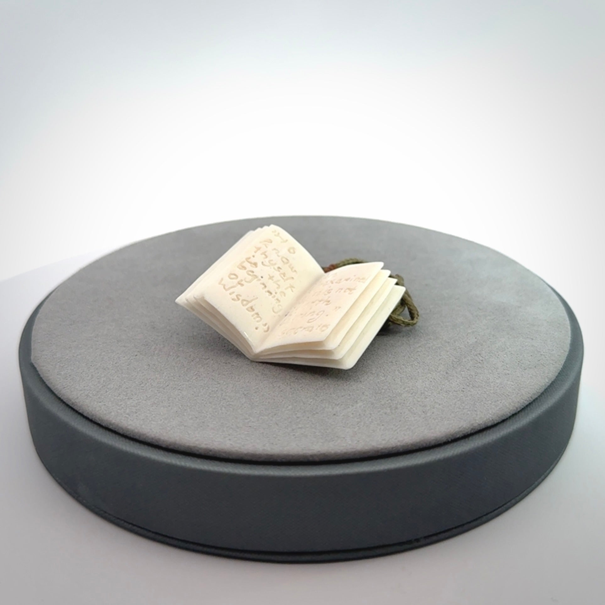 Hand carved open book pendant, hand made in bone.