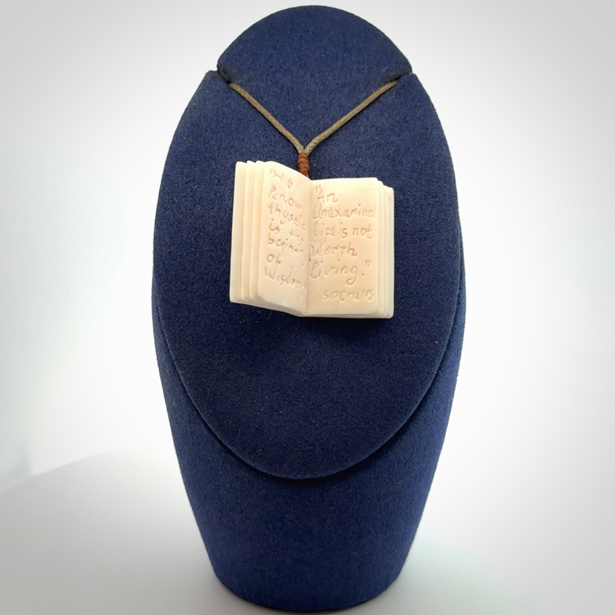 Hand carved open book pendant, hand made in bone.