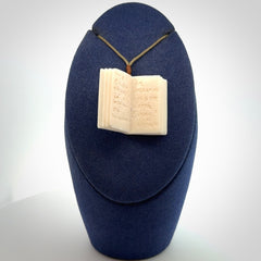 Hand carved open book pendant, hand made in bone.
