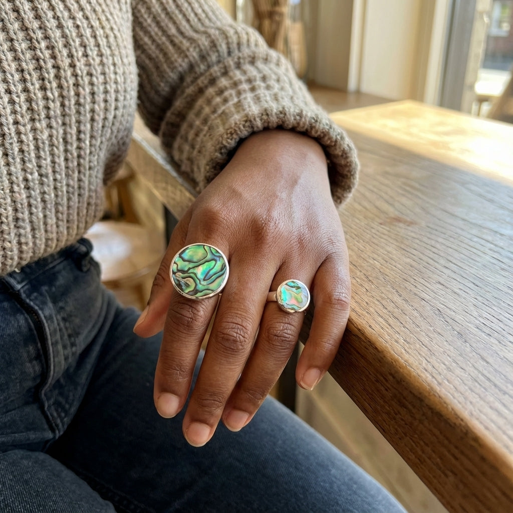 Hand wearing two rings with a natural setting