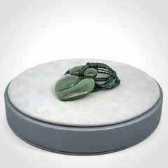 This picture shows a stylised couple in a close embrace sharing a kiss. The pendant is hand carved from a bright faultless piece of British Columbian jade. The cord is a 3-ply plaited green which is adjustable.