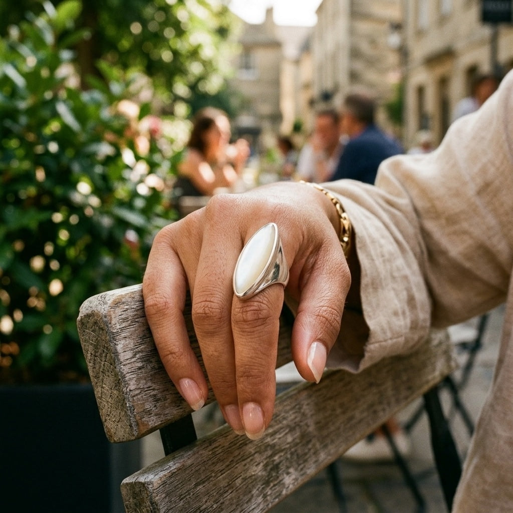 Hand wearing mother of pearl ring
