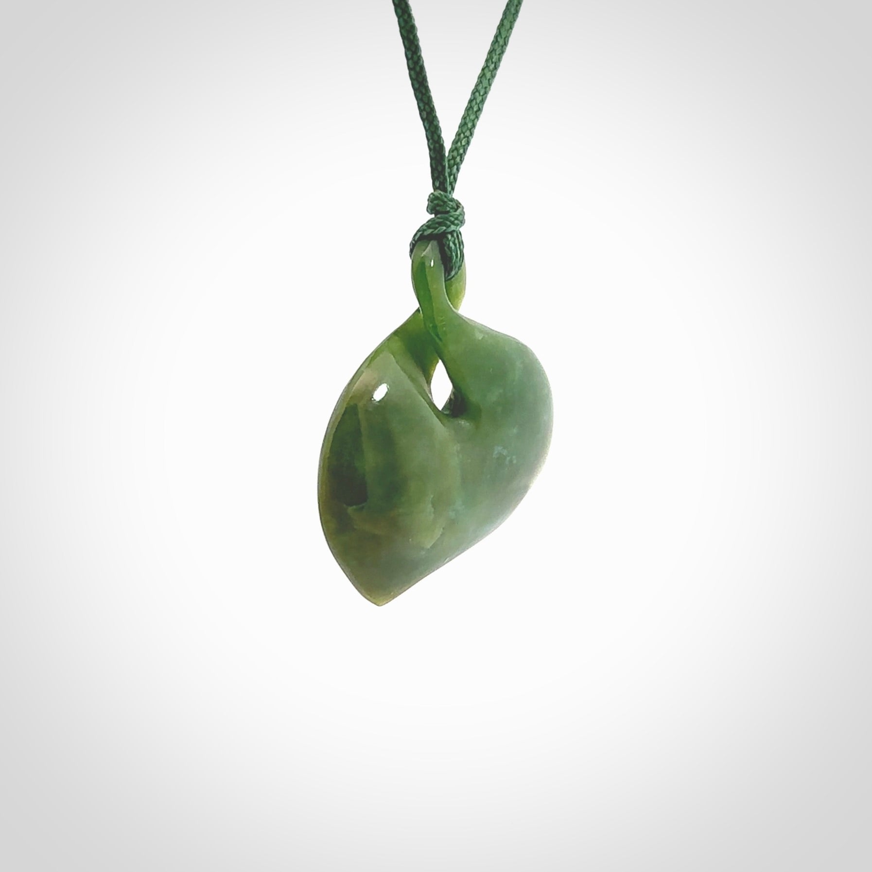 Hand carved New Zealand jade, single twist pendant. Maori pikorua pendant hand carved in New Zealand. Made by NZ Pacific, jade jewellery for sale online. One only hand made by Ross Crump.