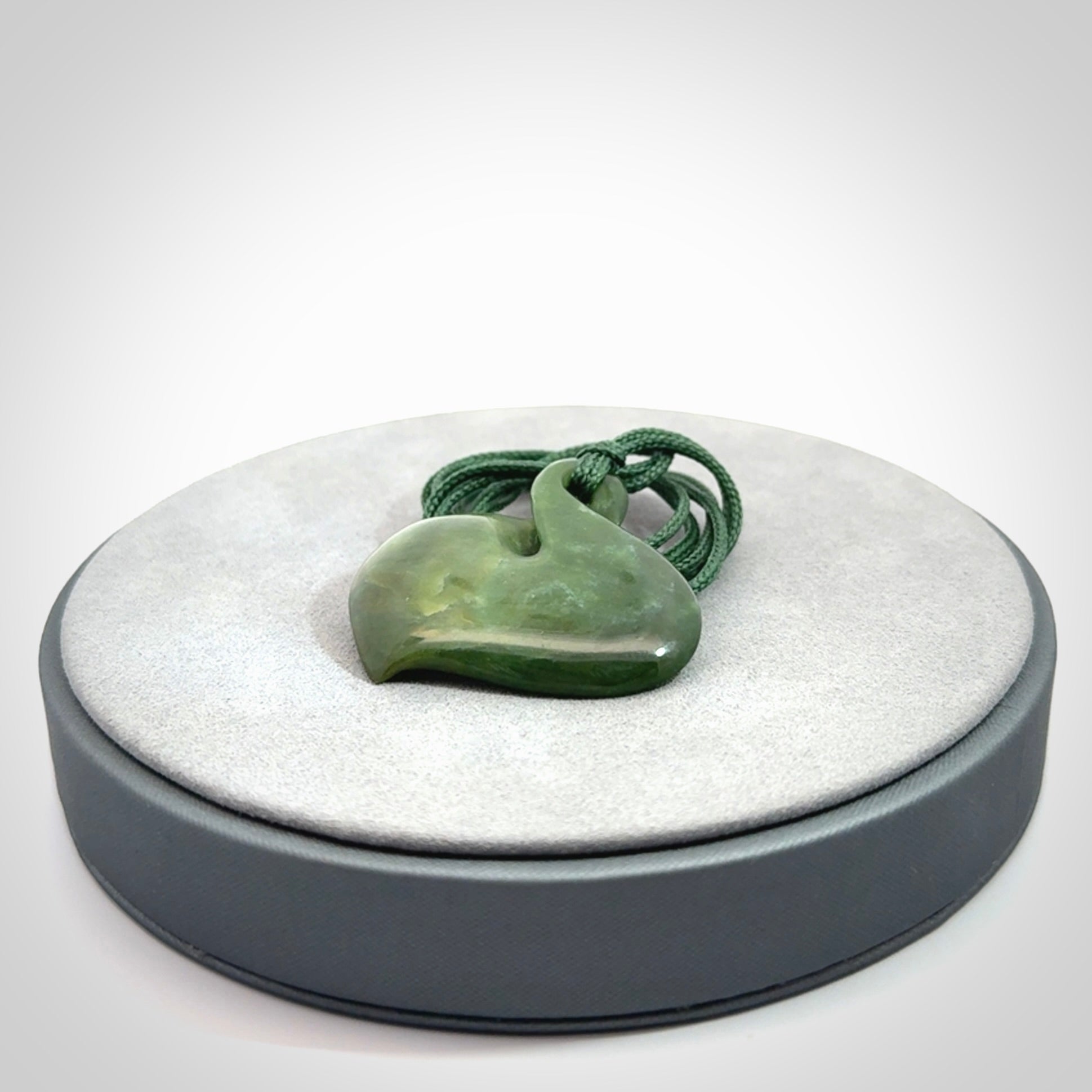 Hand carved New Zealand jade, single twist pendant. Maori pikorua pendant hand carved in New Zealand. Made by NZ Pacific, jade jewellery for sale online. One only hand made by Ross Crump.