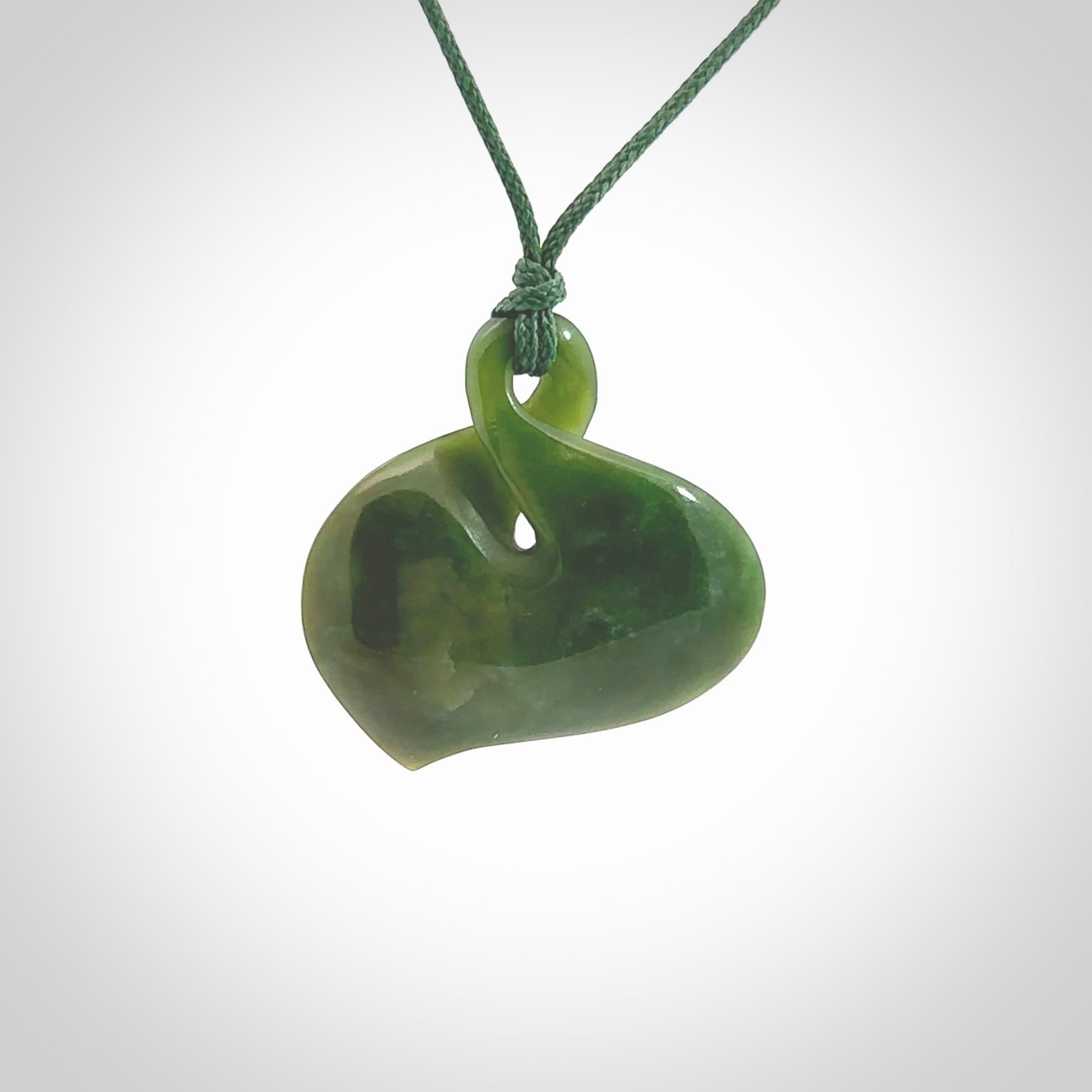 Hand carved New Zealand jade, single twist pendant. Maori pikorua pendant hand carved in New Zealand. Made by NZ Pacific, jade jewellery for sale online. One only hand made by Ross Crump.