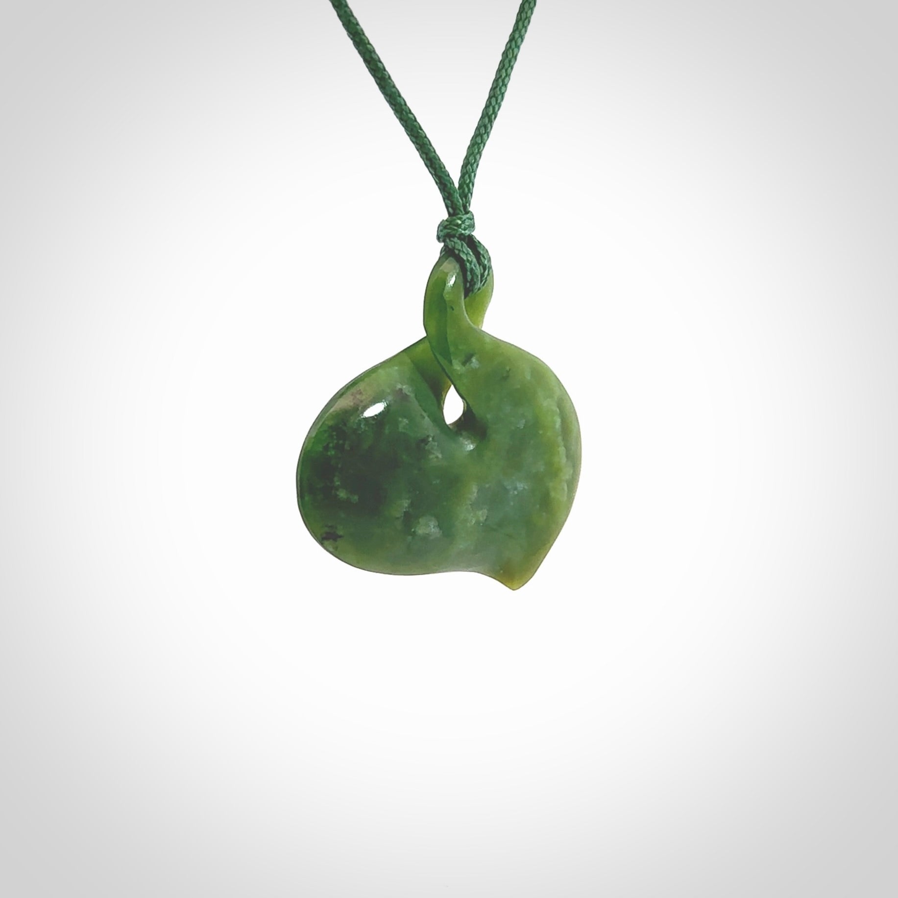 Hand carved New Zealand jade, single twist pendant. Maori pikorua pendant hand carved in New Zealand. Made by NZ Pacific, jade jewellery for sale online. One only hand made by Ross Crump.