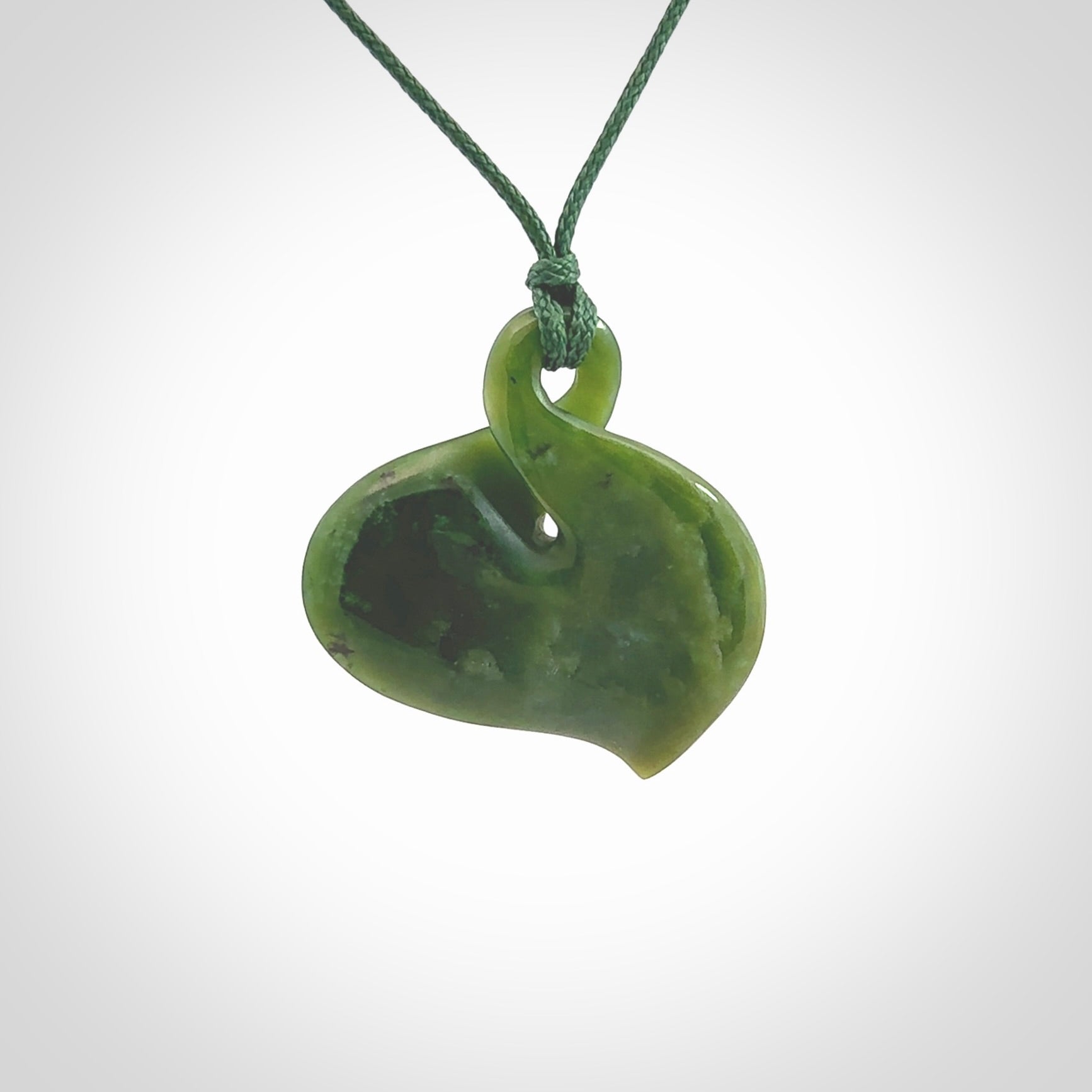 Hand carved New Zealand jade, single twist pendant. Maori pikorua pendant hand carved in New Zealand. Made by NZ Pacific, jade jewellery for sale online. One only hand made by Ross Crump.