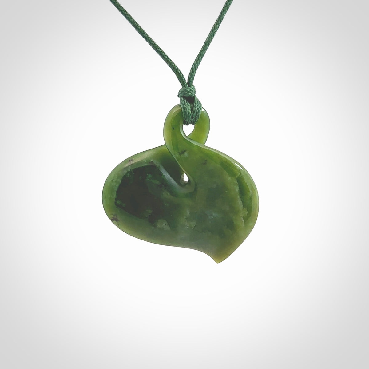 Hand carved New Zealand jade, single twist pendant. Maori pikorua pendant hand carved in New Zealand. Made by NZ Pacific, jade jewellery for sale online. One only hand made by Ross Crump.