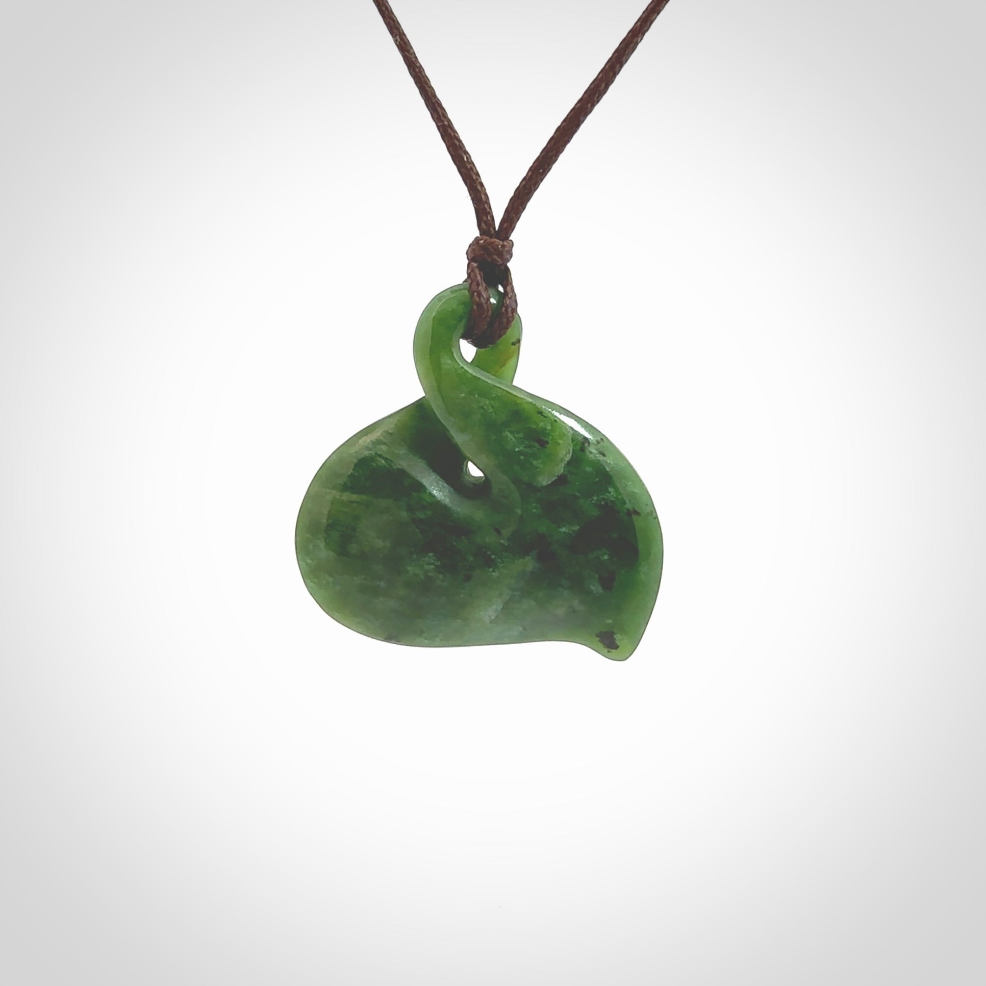 Hand carved New Zealand jade, single twist pendant. Maori pikorua pendant hand carved in New Zealand. Made by NZ Pacific, jade jewellery for sale online. One only hand made by Ross Crump.