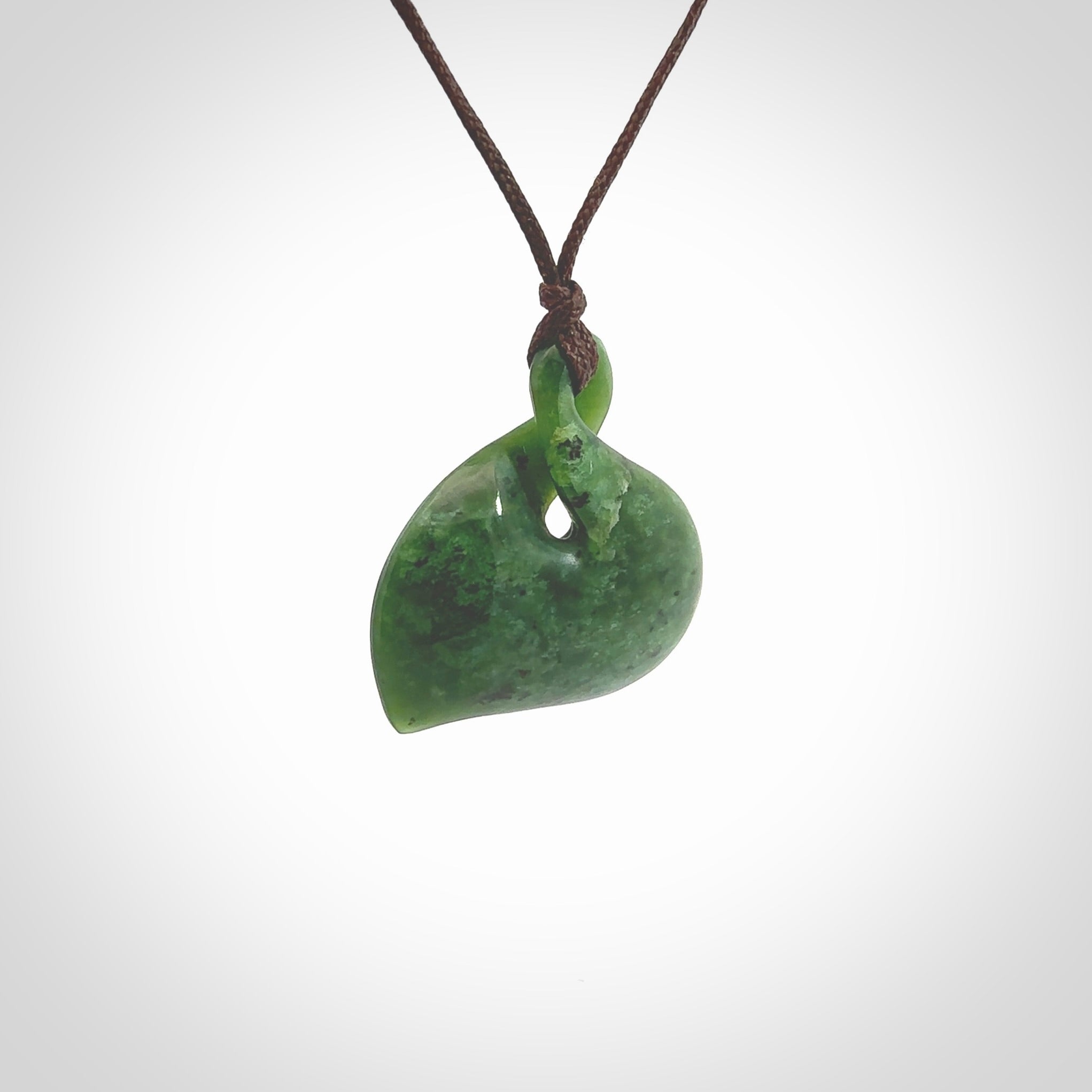 Hand carved New Zealand jade, single twist pendant. Maori pikorua pendant hand carved in New Zealand. Made by NZ Pacific, jade jewellery for sale online. One only hand made by Ross Crump.