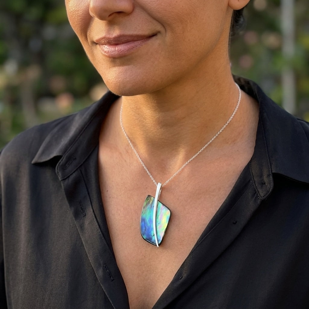 Woman wearing paua shell and sterling silver pendant