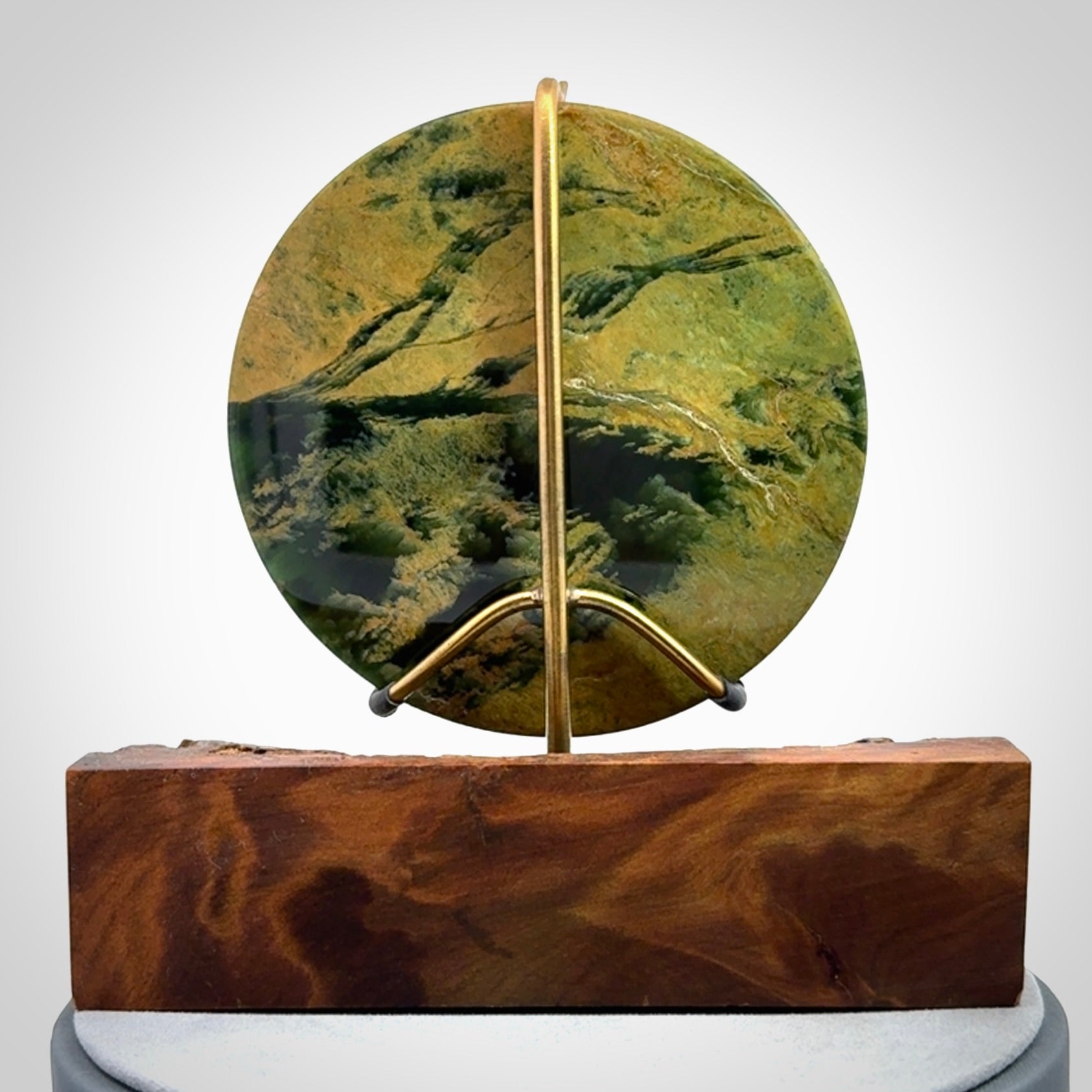 Hand carved New Zealand Flower Jade Disc with wooden stand sculpture. Hand carved here in New Zealand by Alex Sands Studio. This is a 'one only' sculpture, a beautiful display piece.