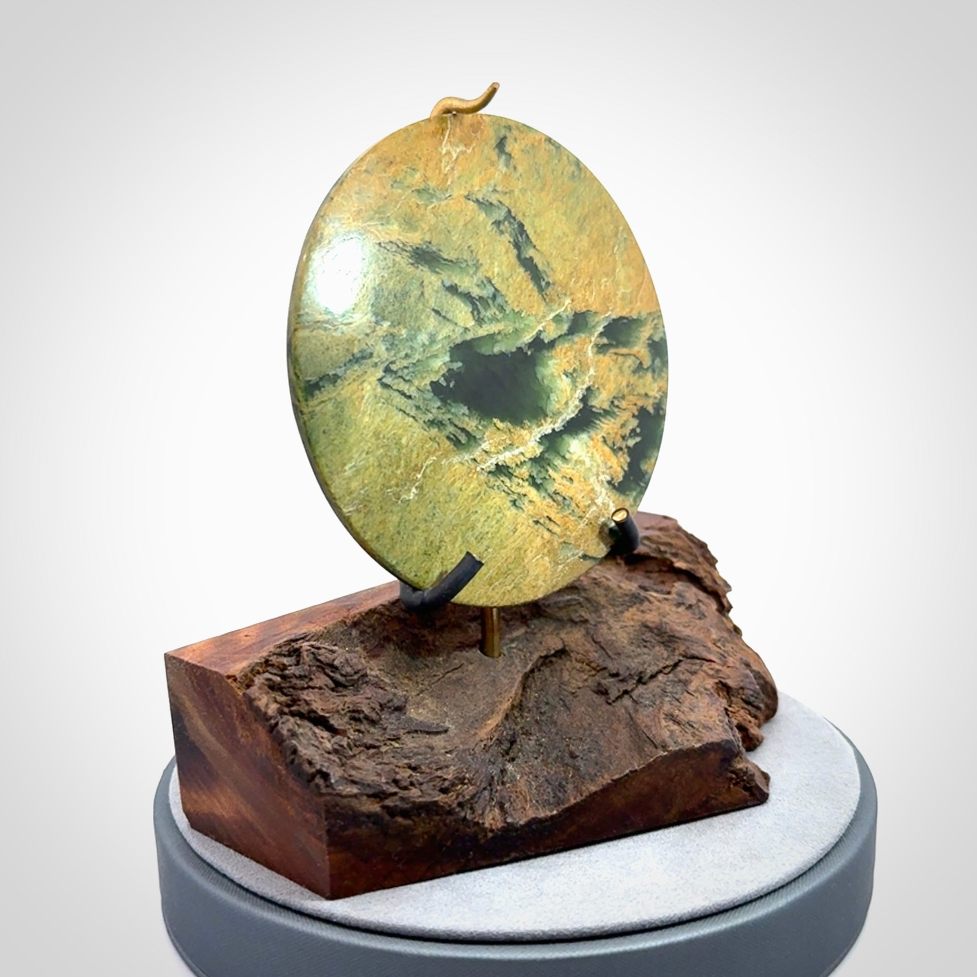 Hand carved New Zealand Flower Jade Disc with wooden stand sculpture. Hand carved here in New Zealand by Alex Sands Studio. This is a 'one only' sculpture, a beautiful display piece.