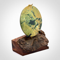 Hand carved New Zealand Flower Jade Disc with wooden stand sculpture. Hand carved here in New Zealand by Alex Sands Studio. This is a 'one only' sculpture, a beautiful display piece.