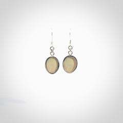 Hand made woolly mammoth tusk moon face earrings. Made by NZ Pacific and sale online only.