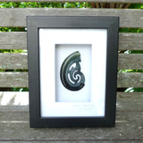 A hand carved large New Zealand Jade Hook, Matau, necklace that has been framed and signed by artist Kerry Thompson. A large sized hand made hook necklace by New Zealand artist Kerry Thompson. One off framed work of art to wear. Delivered with Express Courier.