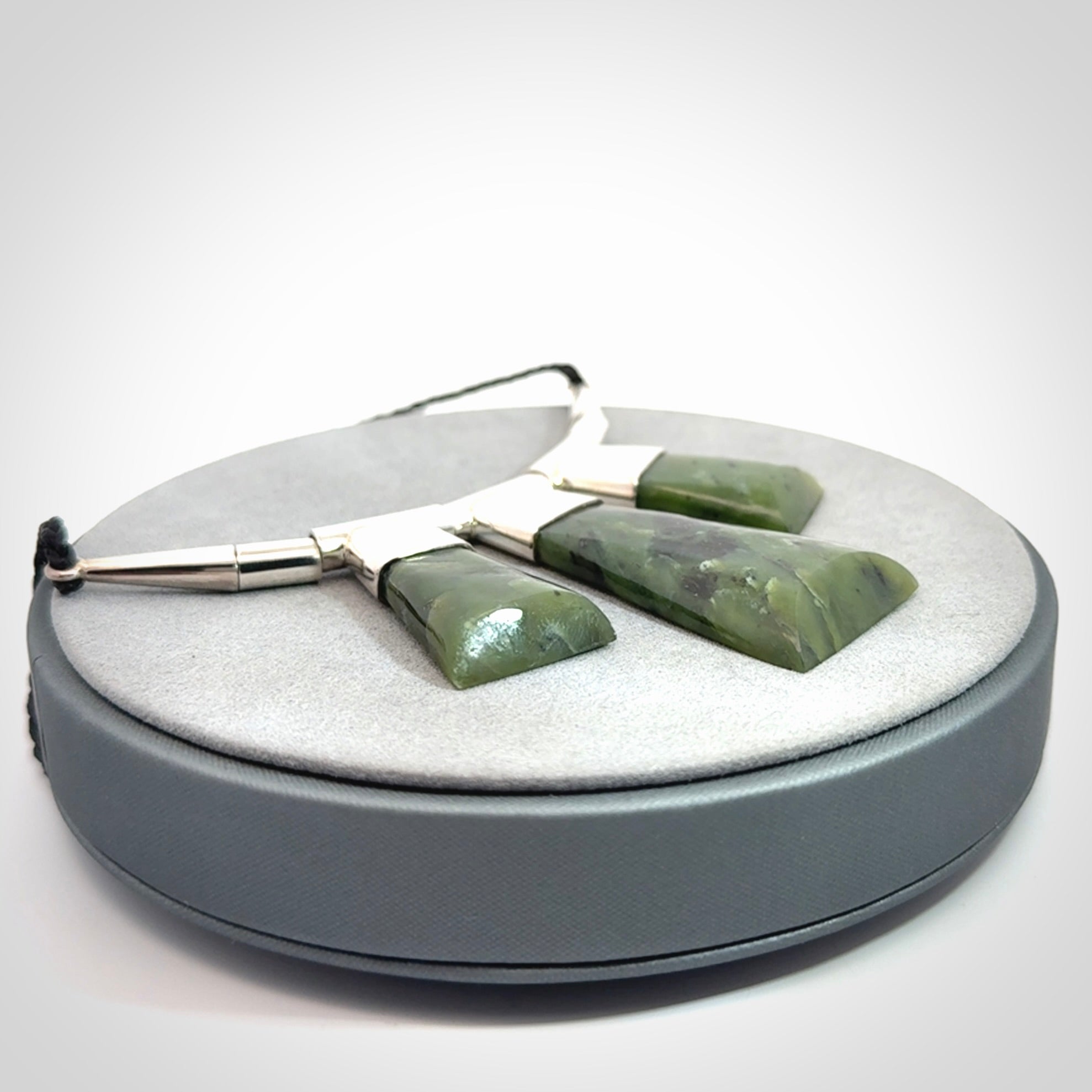 Hand crafted contemporary green jade and sterling silver drop necklace. This necklace is provided with a black adjustable cord. Contemporary three jade drops necklace with sterling silver.