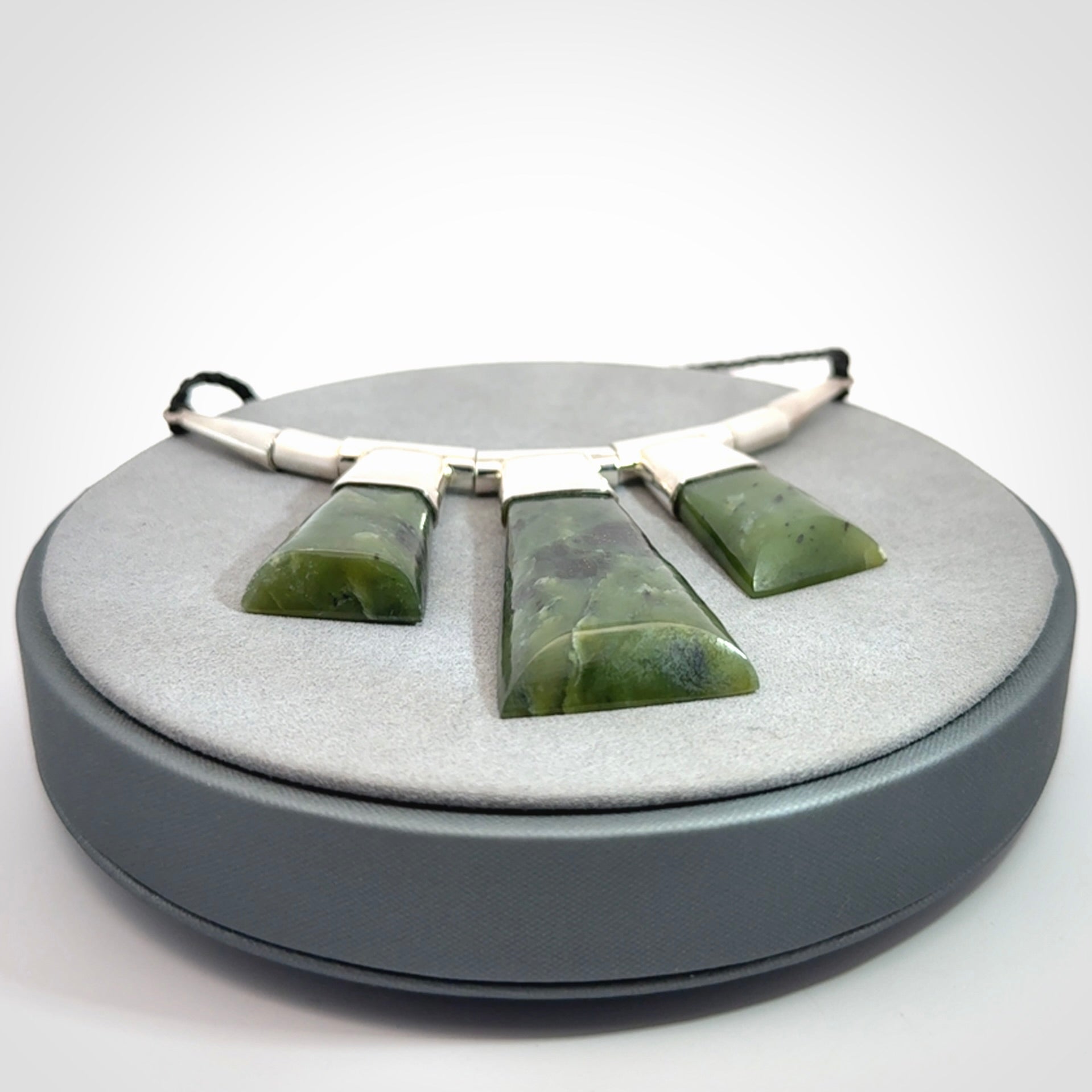 Hand crafted contemporary green jade and sterling silver drop necklace. This necklace is provided with a black adjustable cord. Contemporary three jade drops necklace with sterling silver.