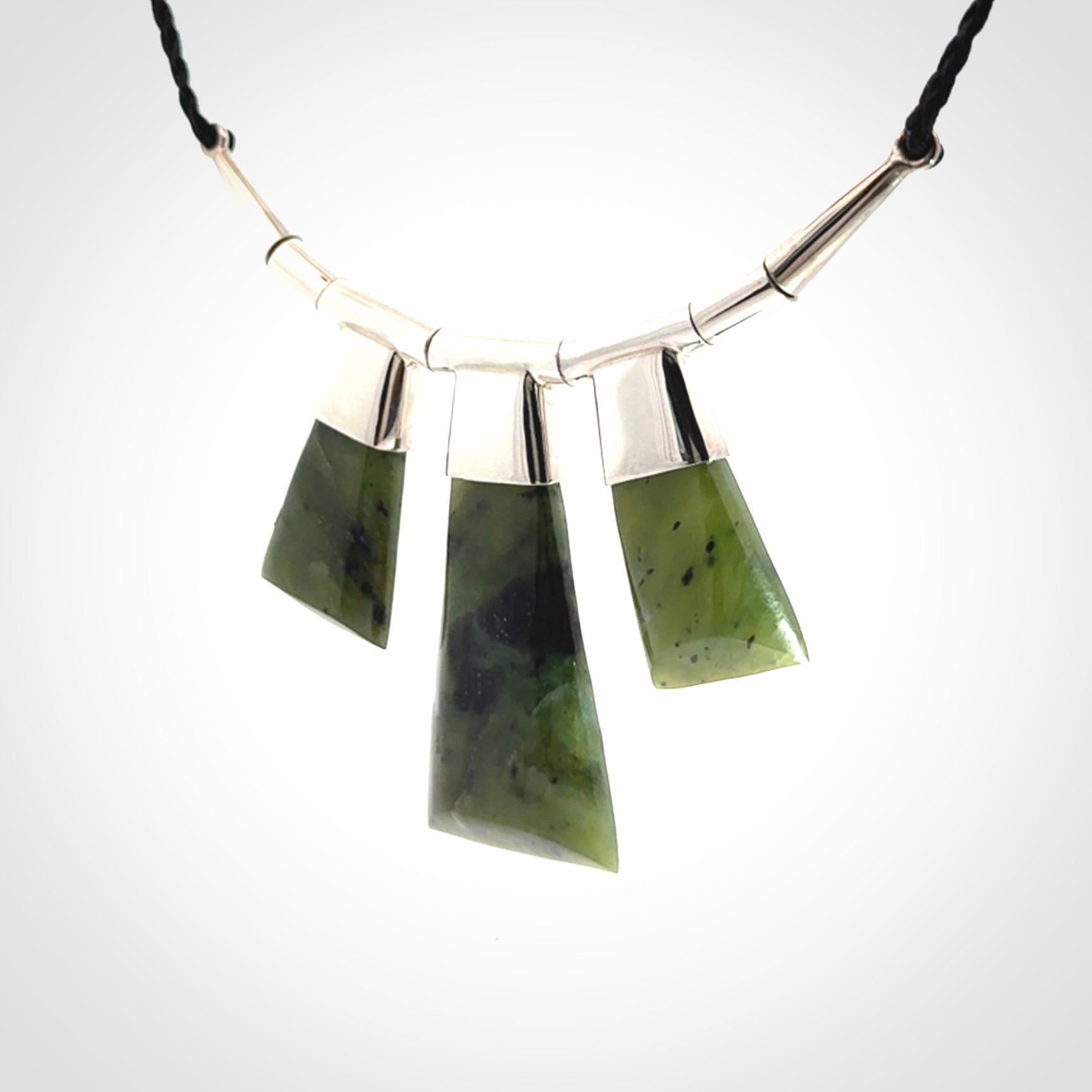 Hand crafted contemporary green jade and sterling silver drop necklace. This necklace is provided with a black adjustable cord. Contemporary three jade drops necklace with sterling silver.