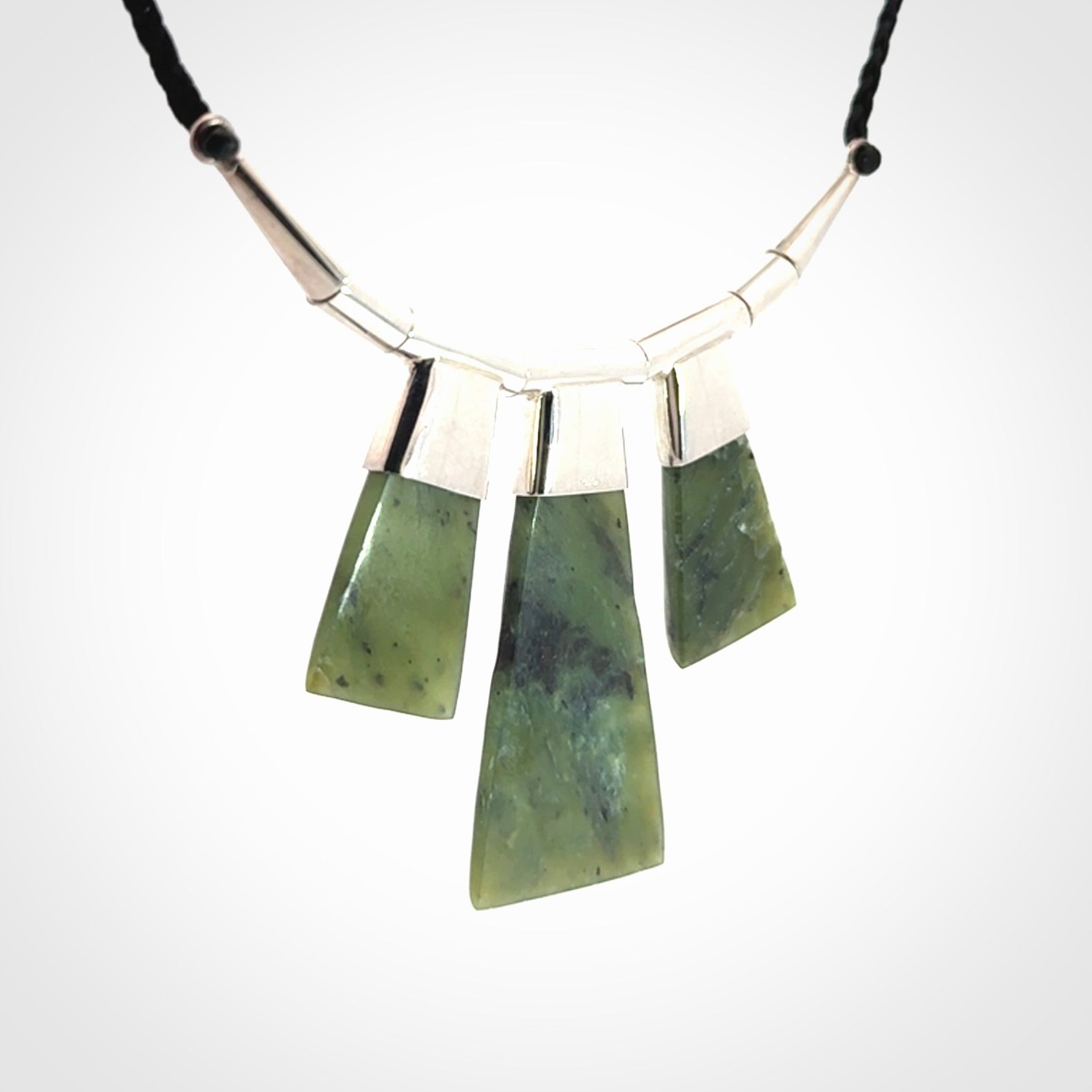 Hand crafted contemporary green jade and sterling silver drop necklace. This necklace is provided with a black adjustable cord. Contemporary three jade drops necklace with sterling silver.