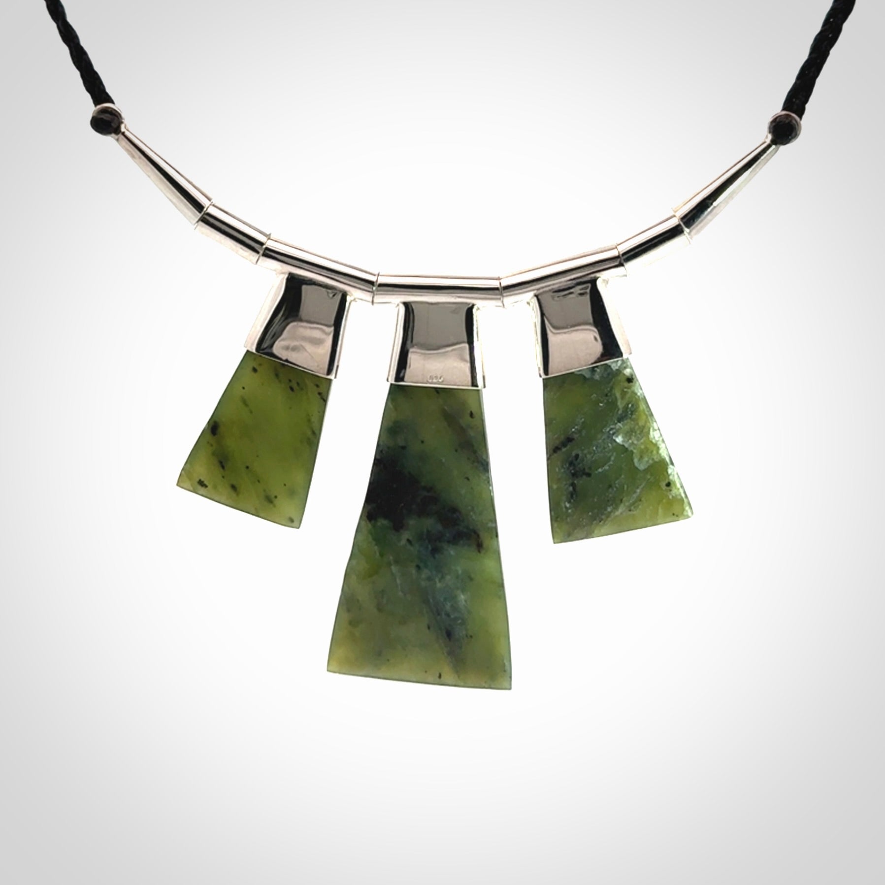 Hand crafted contemporary green jade and sterling silver drop necklace. This necklace is provided with a black adjustable cord. Contemporary three jade drops necklace with sterling silver.