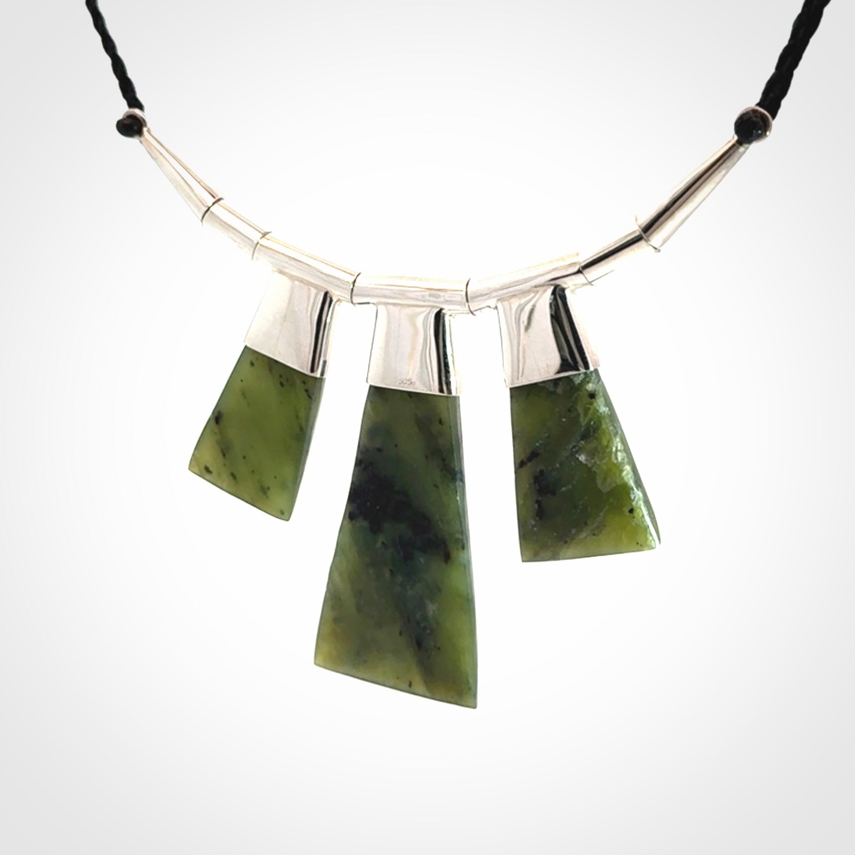 Hand crafted contemporary green jade and sterling silver drop necklace. This necklace is provided with a black adjustable cord. Contemporary three jade drops necklace with sterling silver.