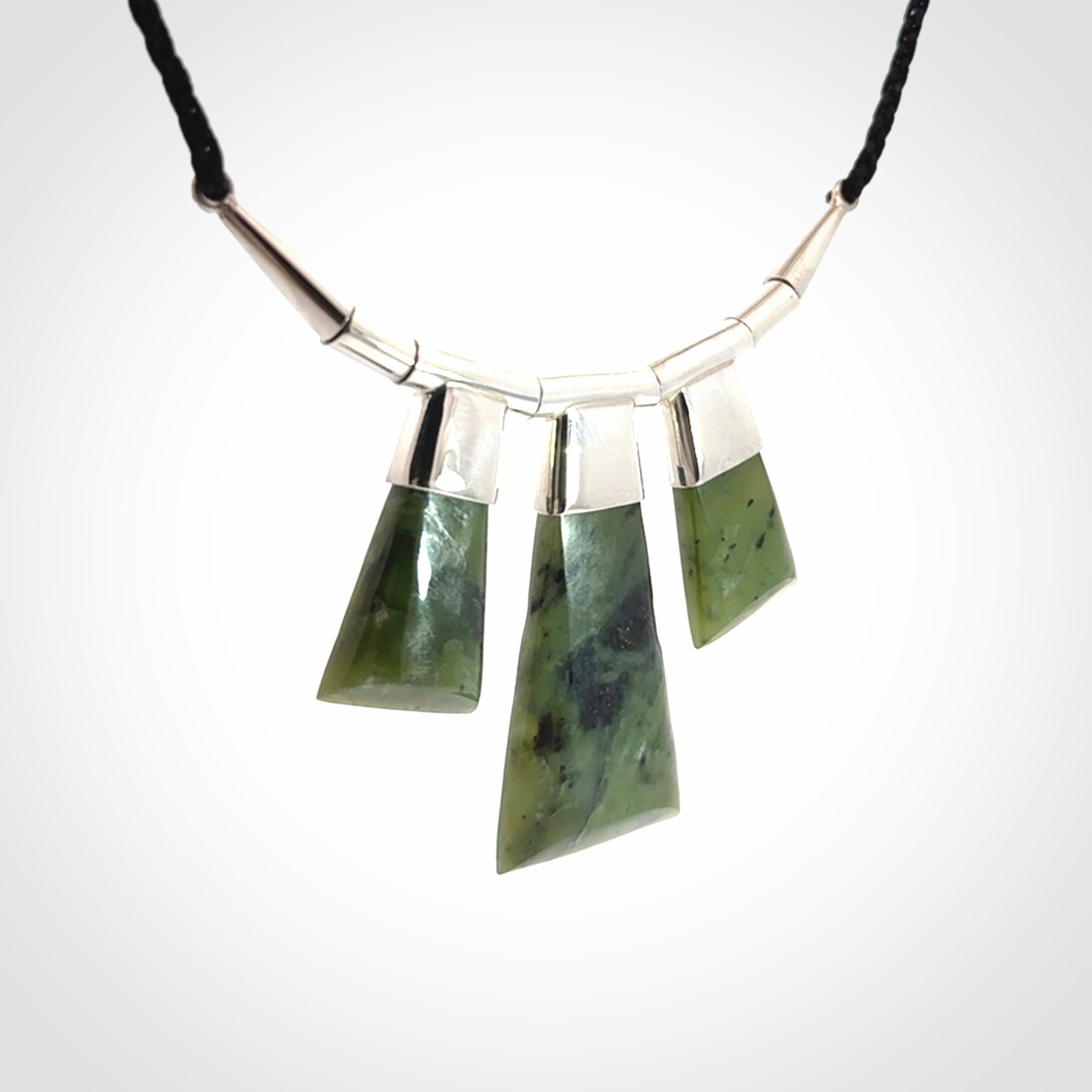 Hand crafted contemporary green jade and sterling silver drop necklace. This necklace is provided with a black adjustable cord. Contemporary three jade drops necklace with sterling silver.