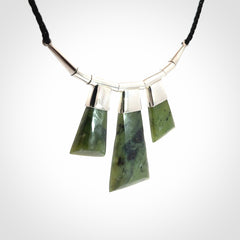 Hand crafted contemporary green jade and sterling silver drop necklace. This necklace is provided with a black adjustable cord. Contemporary three jade drops necklace with sterling silver.