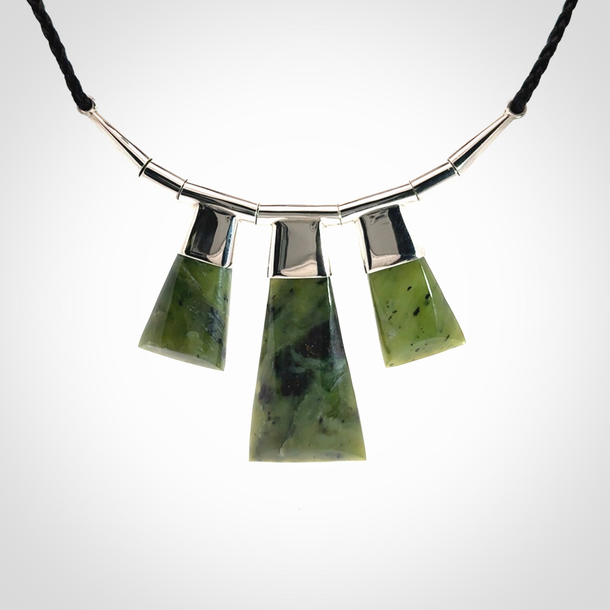 Hand crafted contemporary green jade and sterling silver drop necklace. This necklace is provided with a black adjustable cord. Contemporary three jade drops necklace with sterling silver.