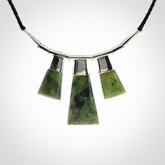 Hand crafted contemporary green jade and sterling silver drop necklace. This necklace is provided with a black adjustable cord. Contemporary three jade drops necklace with sterling silver.