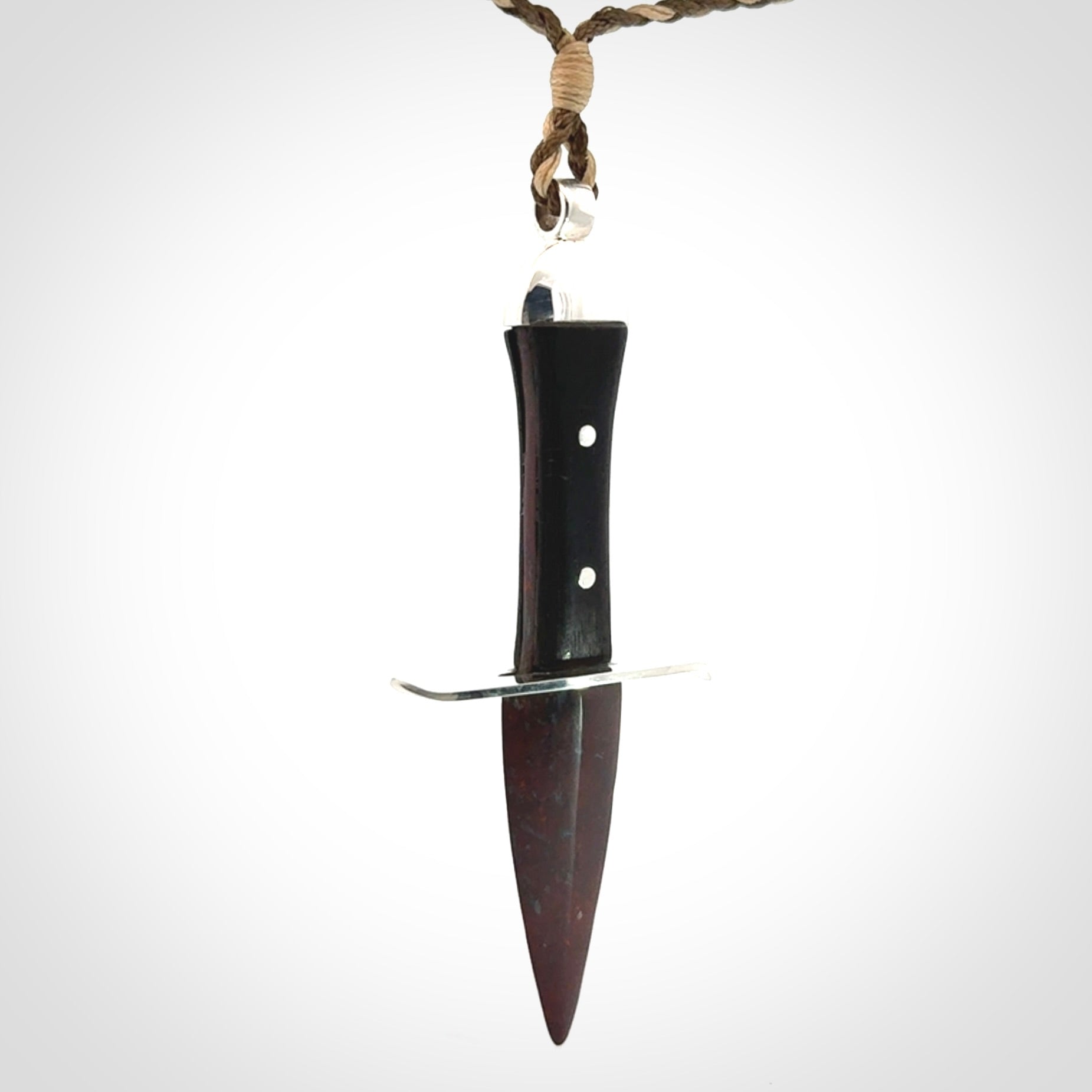 A striking hand carved knife pendant. These are carved with a Red Jasper Stone head and a hardwood handle. The cords are hand plaited in our waxed polyester which is robust, strong and durable. We ship these worldwide with express courier.