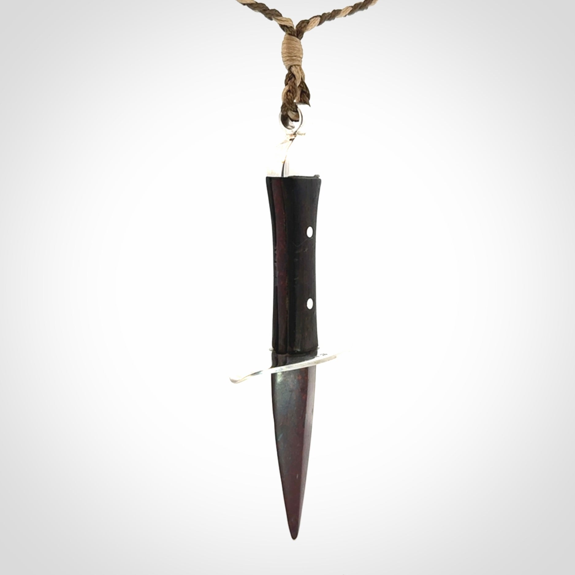 A striking hand carved knife pendant. These are carved with a Red Jasper Stone head and a hardwood handle. The cords are hand plaited in our waxed polyester which is robust, strong and durable. We ship these worldwide with express courier.